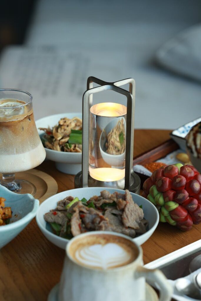 Sumptuous dining table setup featuring gourmet dishes, sophisticated drinks, and elegant lighting.